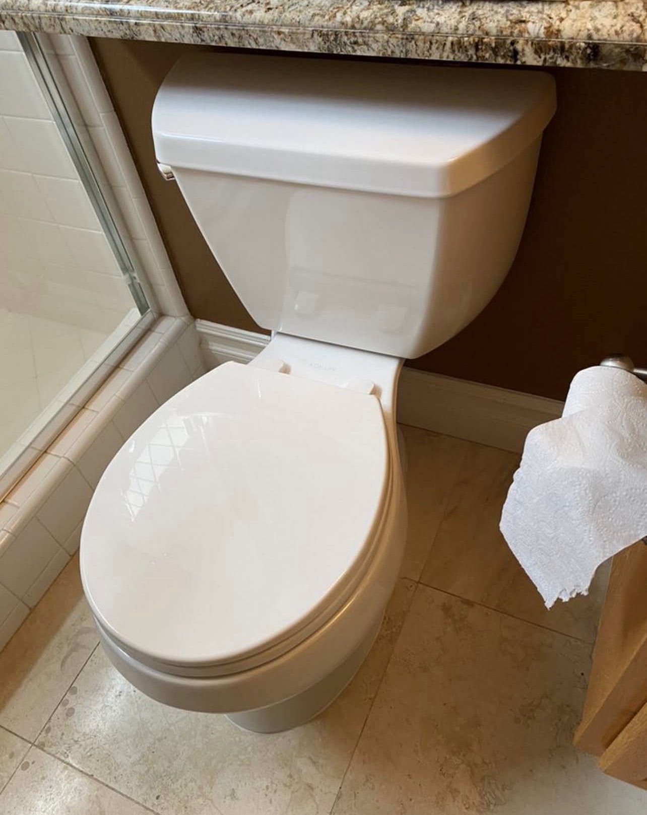 A freshly installed white toilet, set and sealed cleanly
